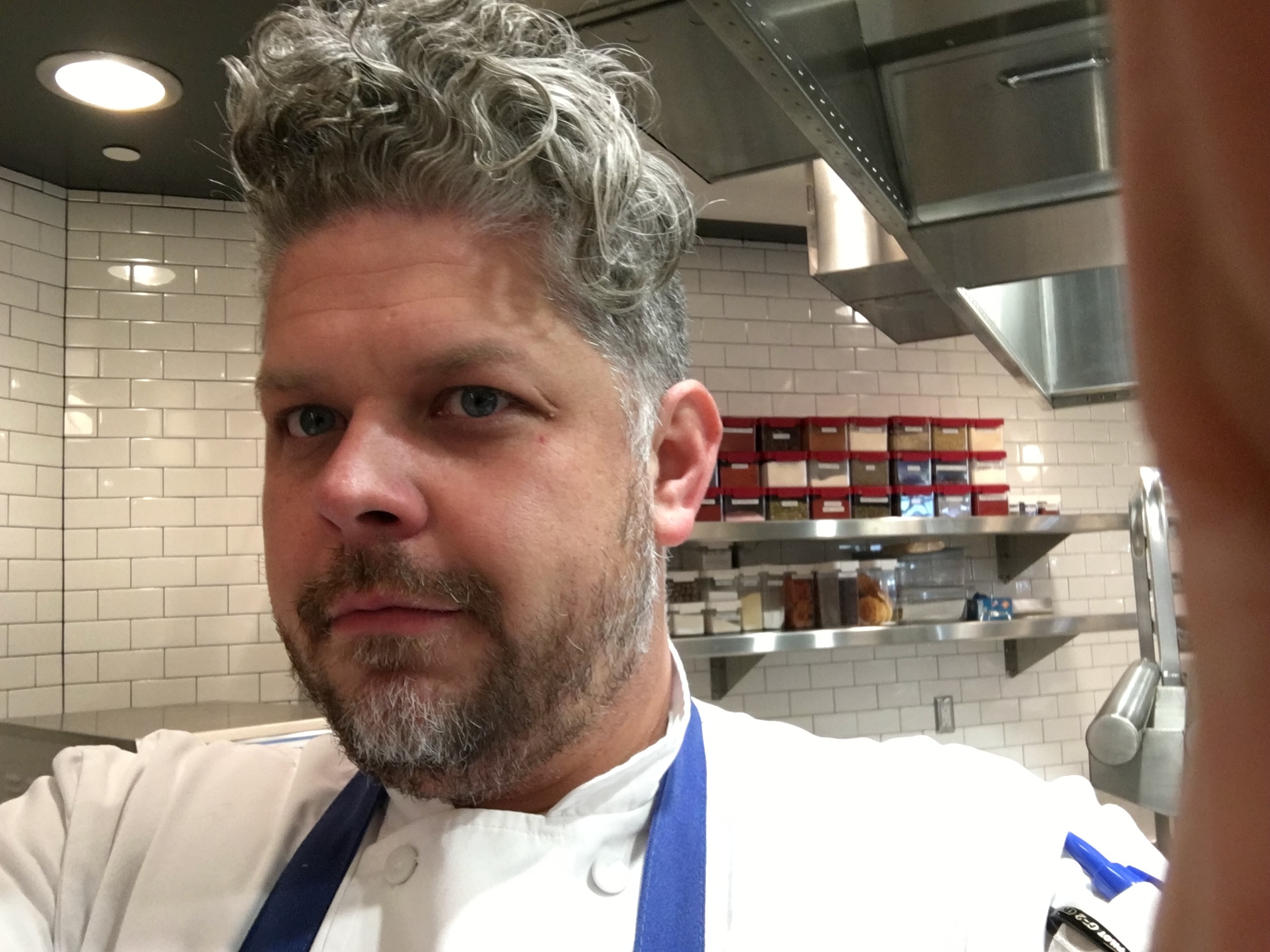 In chef whites, kitchen